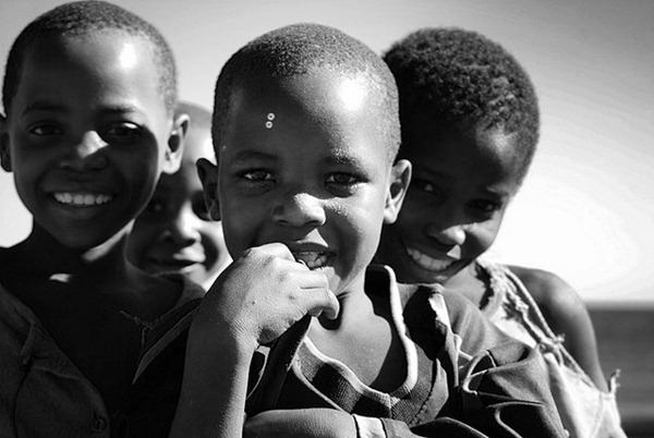 Village children inspect me and my camera